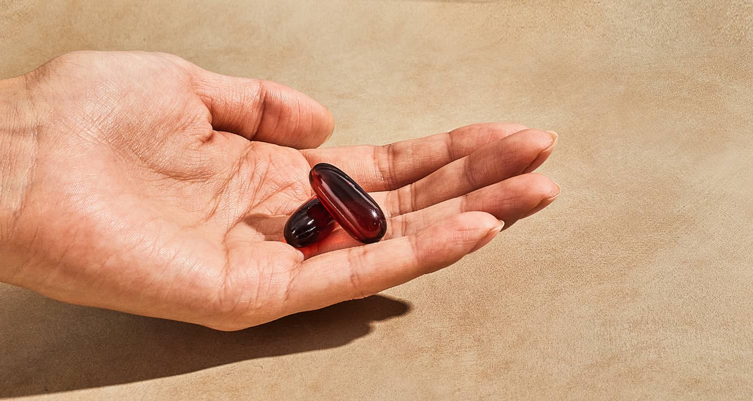 hand holding fish oil supplement
